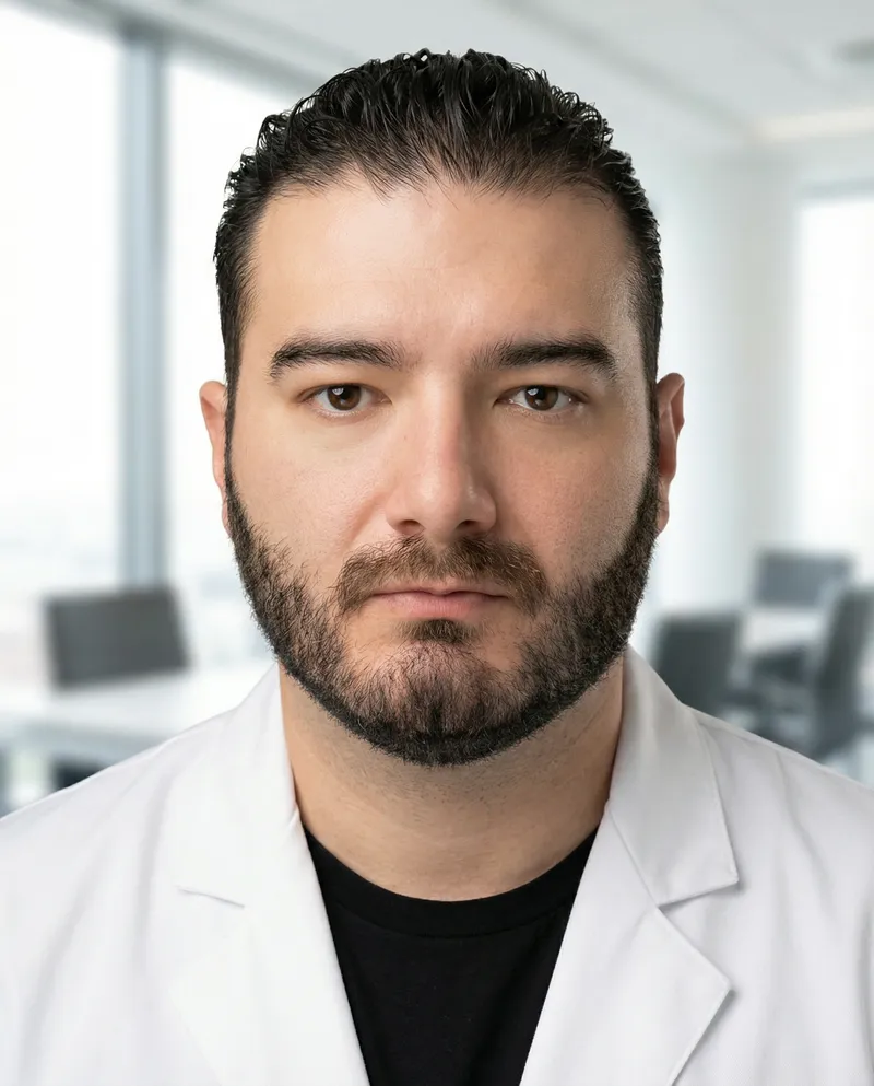 Dr. Marcos Eduardo Meza en su oficina con bata de hospital